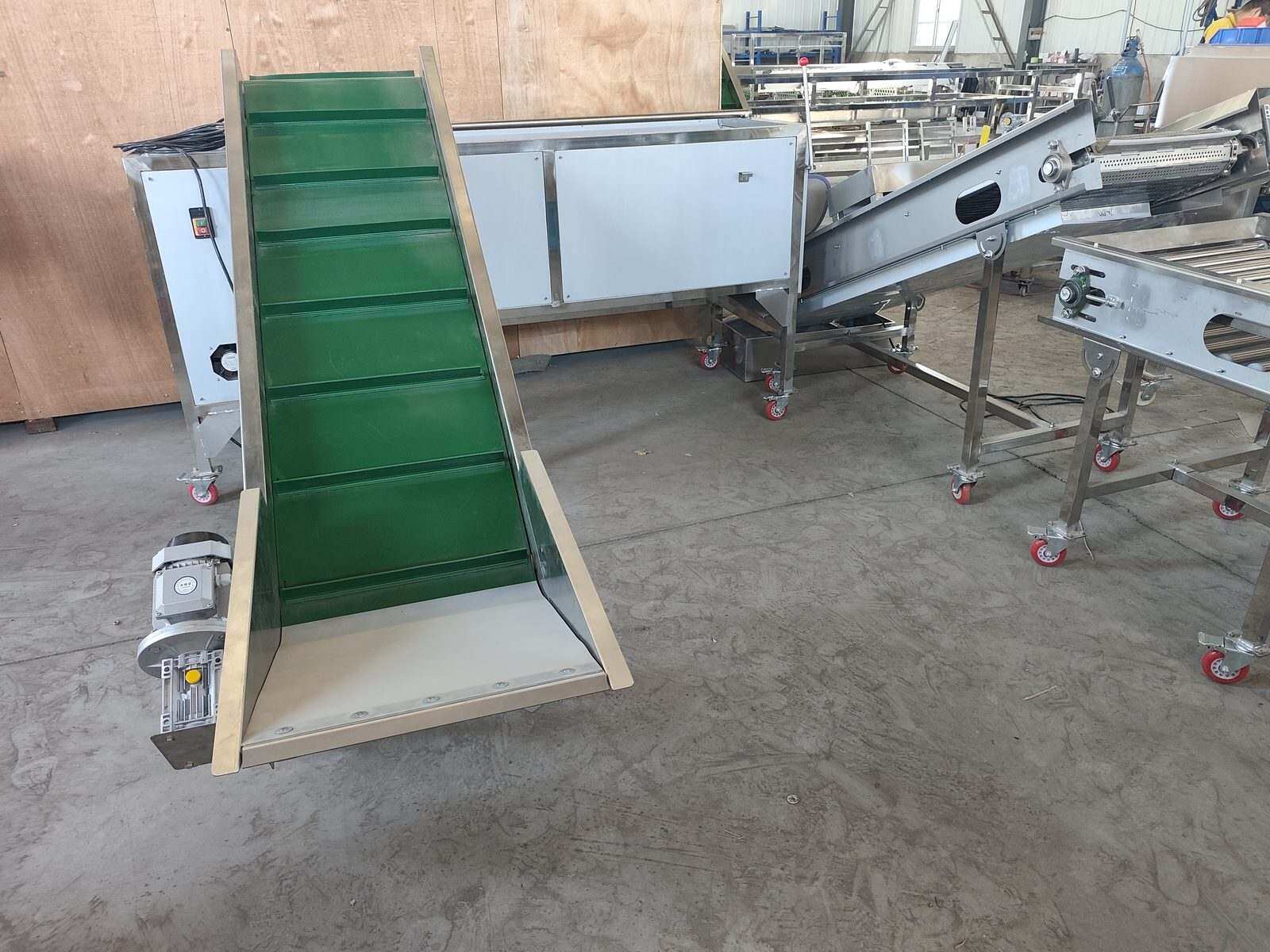 Elevating conveyor connecting different sections of the potato processing line